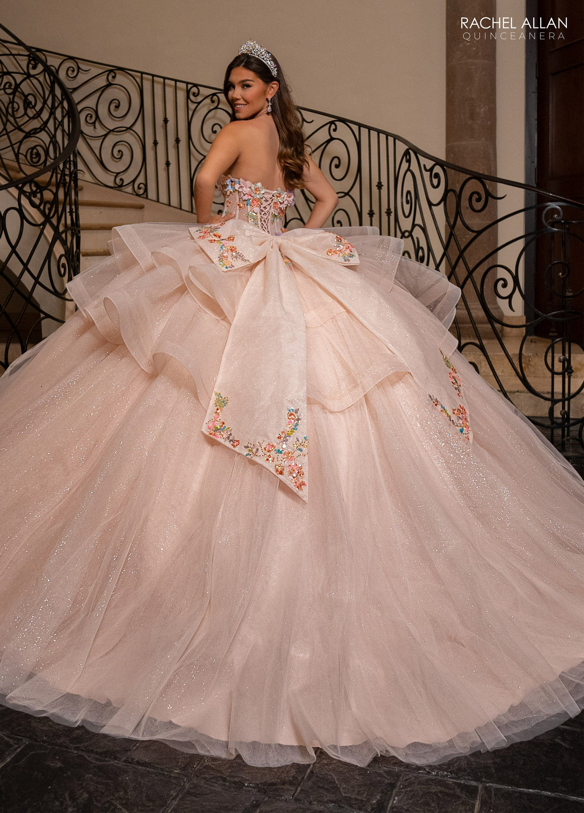 Blush Pink Ballgown with Ruffled Skirt and Floral Bow Blush Pink Ballgown with Ruffled Skirt and Floral Bow — Quinceanera Dresses