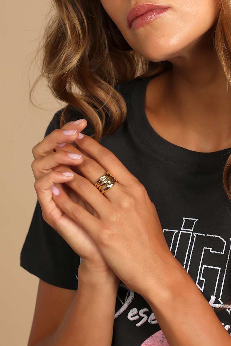 Wavy Gold Bands Against a Black Tee Wavy Gold Bands Against a Black Tee — Stacked Rings