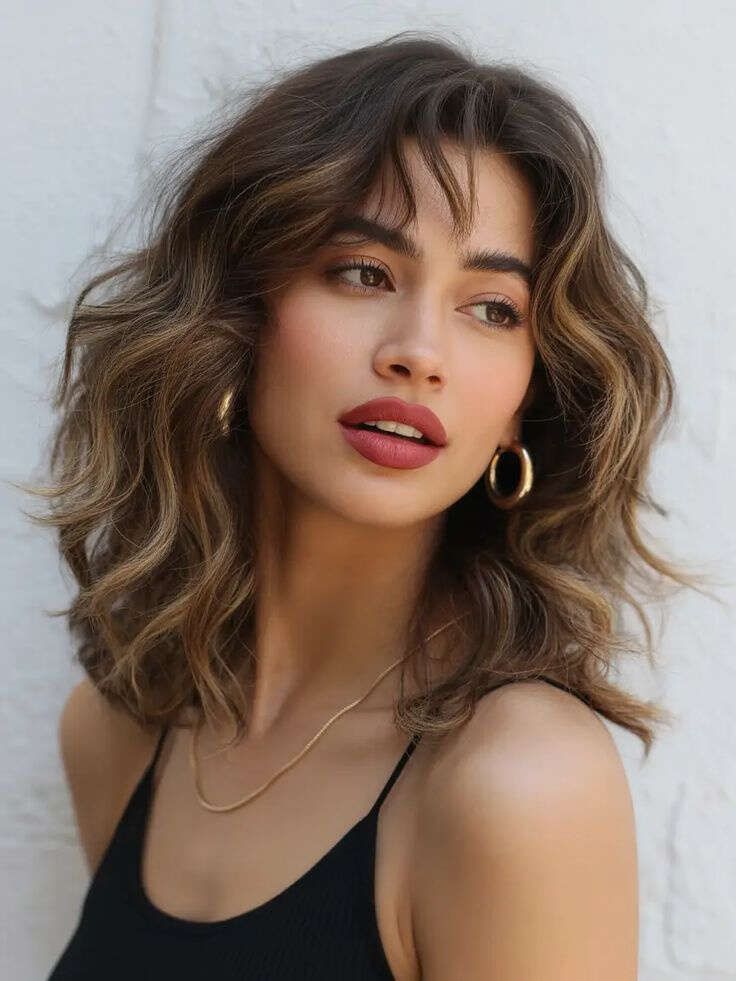 Dark Brown With Subtle Highlights Collarbone Length Shag With Wispy Bangs — Haircuts for Wavy Hair