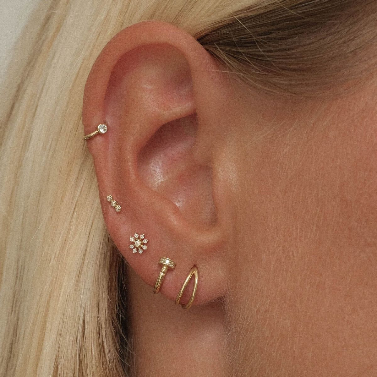 Subtle Gold Ear Stack Featuring a Flower Stud Subtle Gold Ear Stack Featuring a Flower Stud — Ear Piercing Ideas