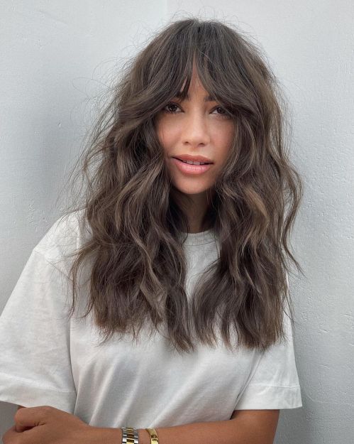 Mid-Back Wavy Dark Brown Blowout with Curtain Bangs — Hairstyles for Long Faces