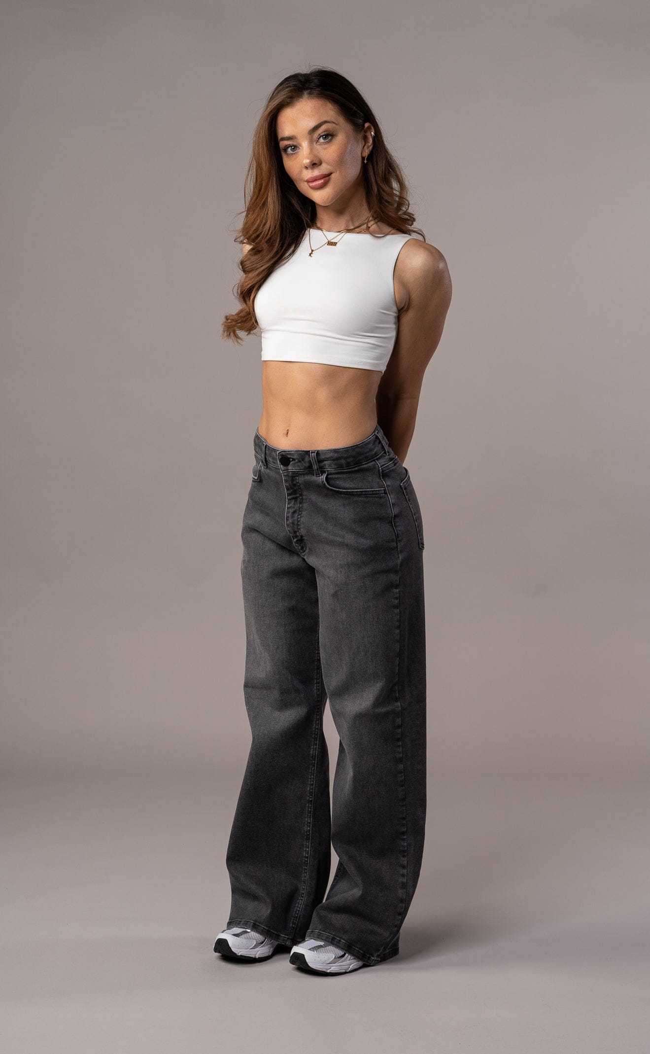 Grey Baggy Jeans with Cropped White Tank and Sneakers