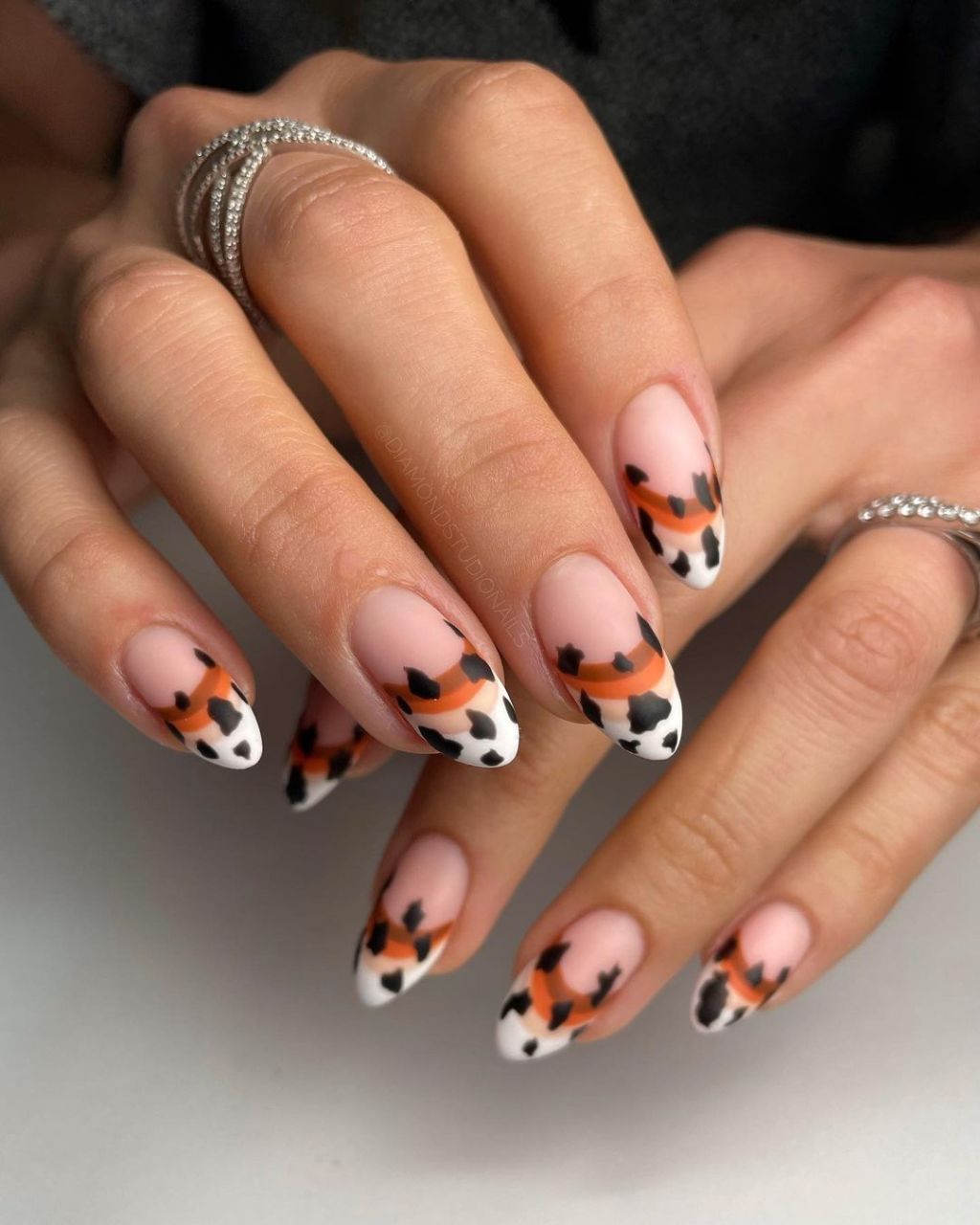 Medium Almond Cow Print and Orange Stripe Tips — Western Nails