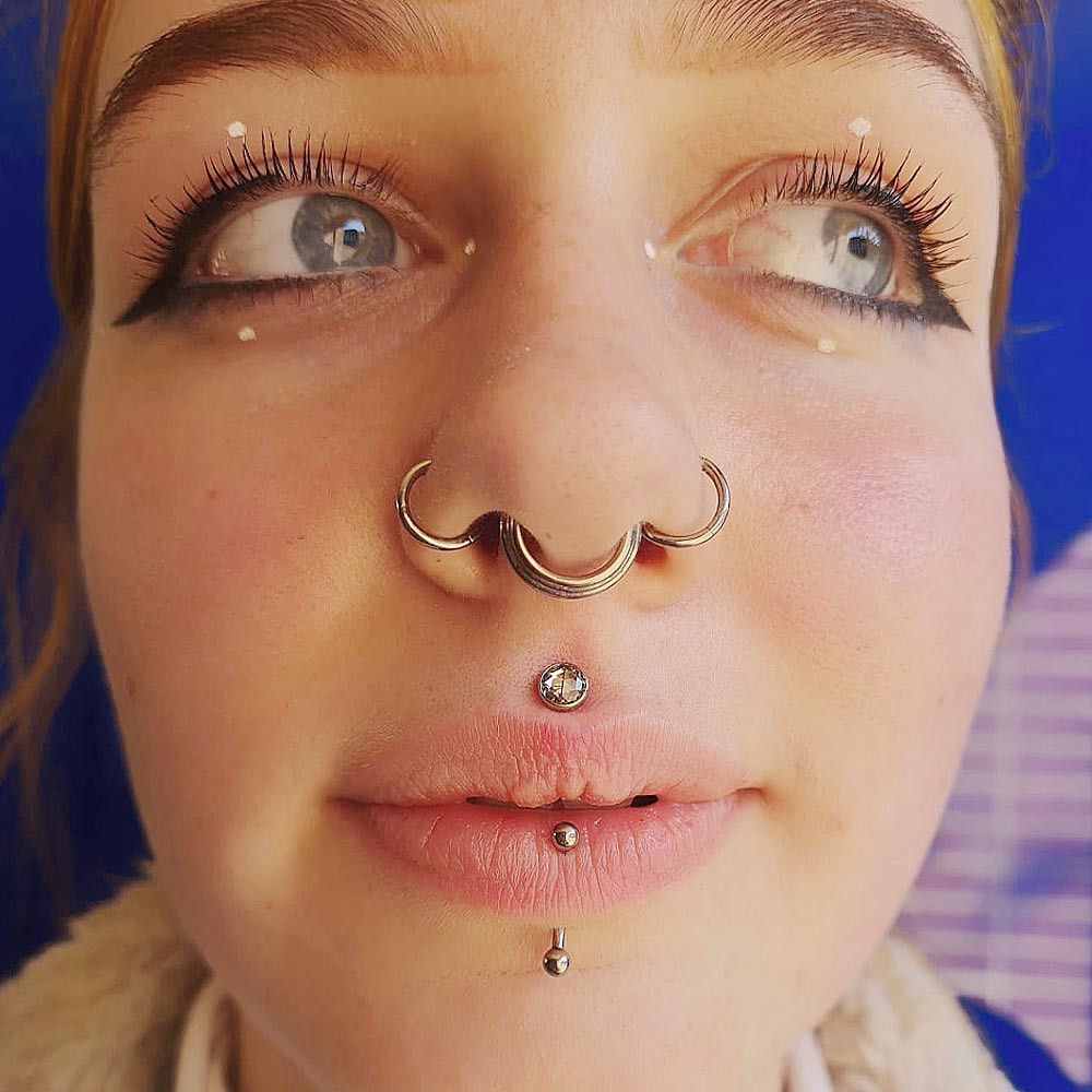Ornate Silver Septum Ring with Lip Piercing and White Jacket Ornate Silver Septum Ring with Lip Piercing and White Jacket — Septum Piercing Ideas