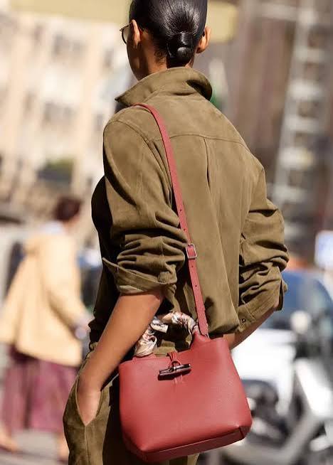 Olive Green Jacket Paired with a Red Leather Bucket Bag Olive Green Jacket Paired with a Red Leather Bucket Bag — Shoulder Bags