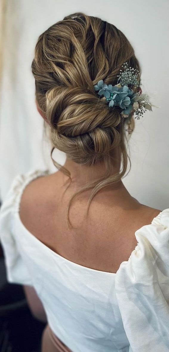 Low Updo With Floral Accessory — Prom Hairstyles for Medium Hair