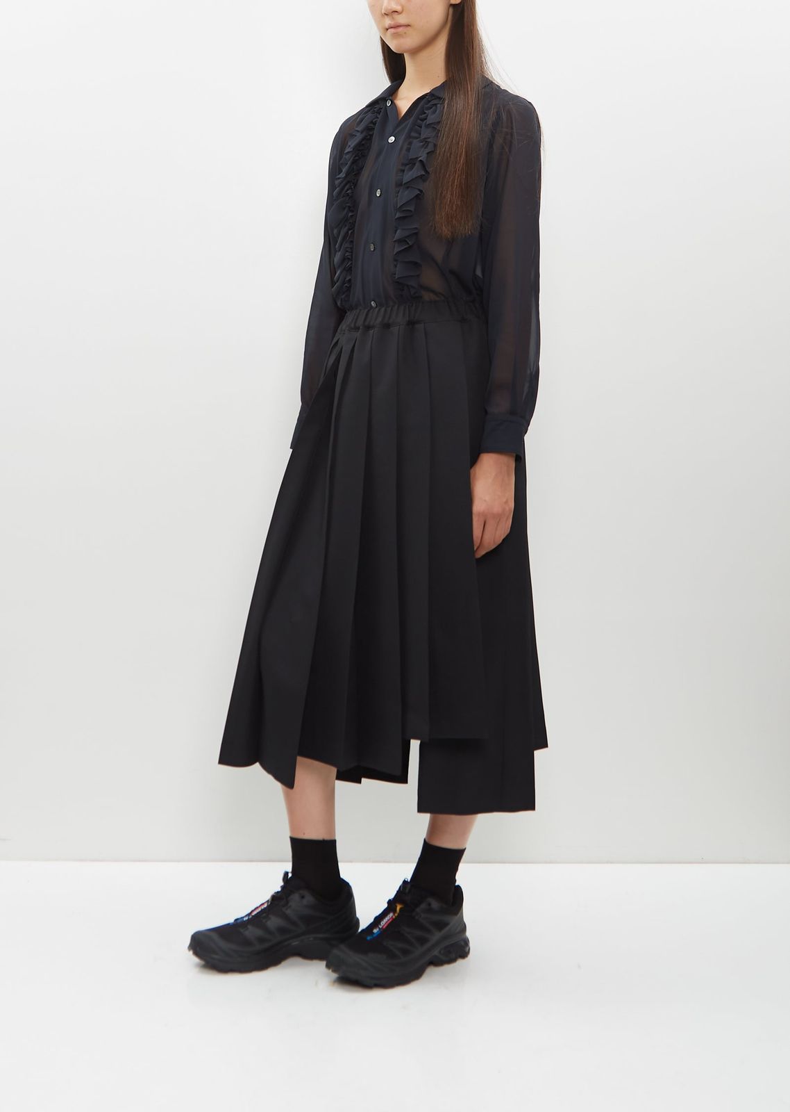 Monochromatic Edge: Sheer Blouse and Pleated Skirt with Black Salomon Trail Runners Monochromatic Edge: Sheer Blouse and Pleated Skirt with Black Salomon Trail Runners — Salomon Outfits