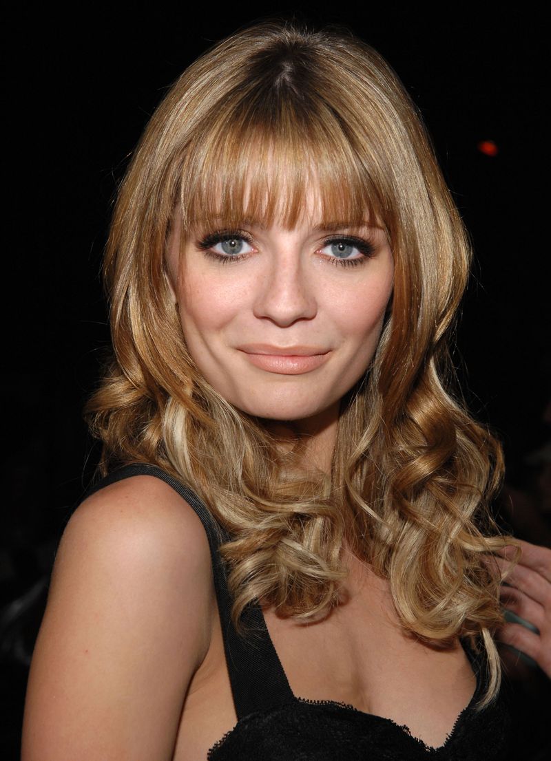 Evening Glam: Blonde Hair with Blunt Bangs and a Black Ribbed Knit Top — Long Bangs