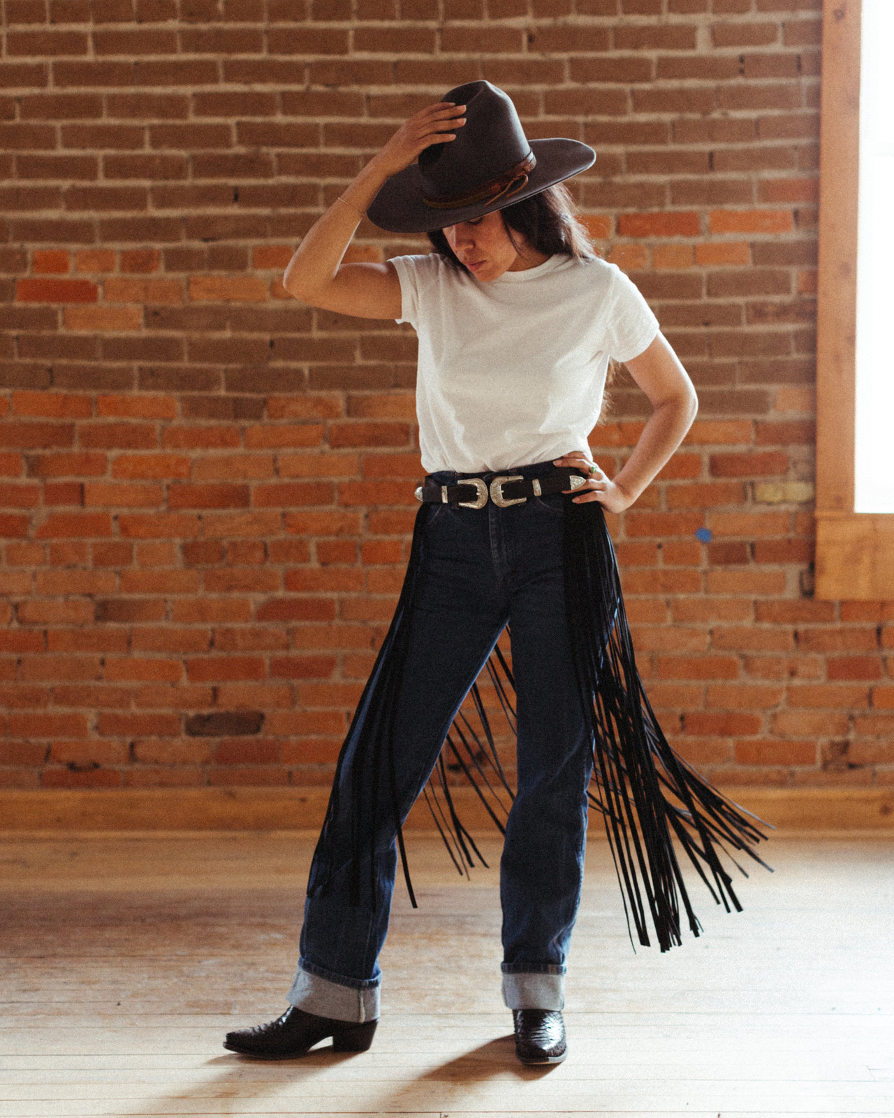 Bold Fringe Pants Paired with a Black Western Belt and Cowboy Hat — Western Belt Outfits