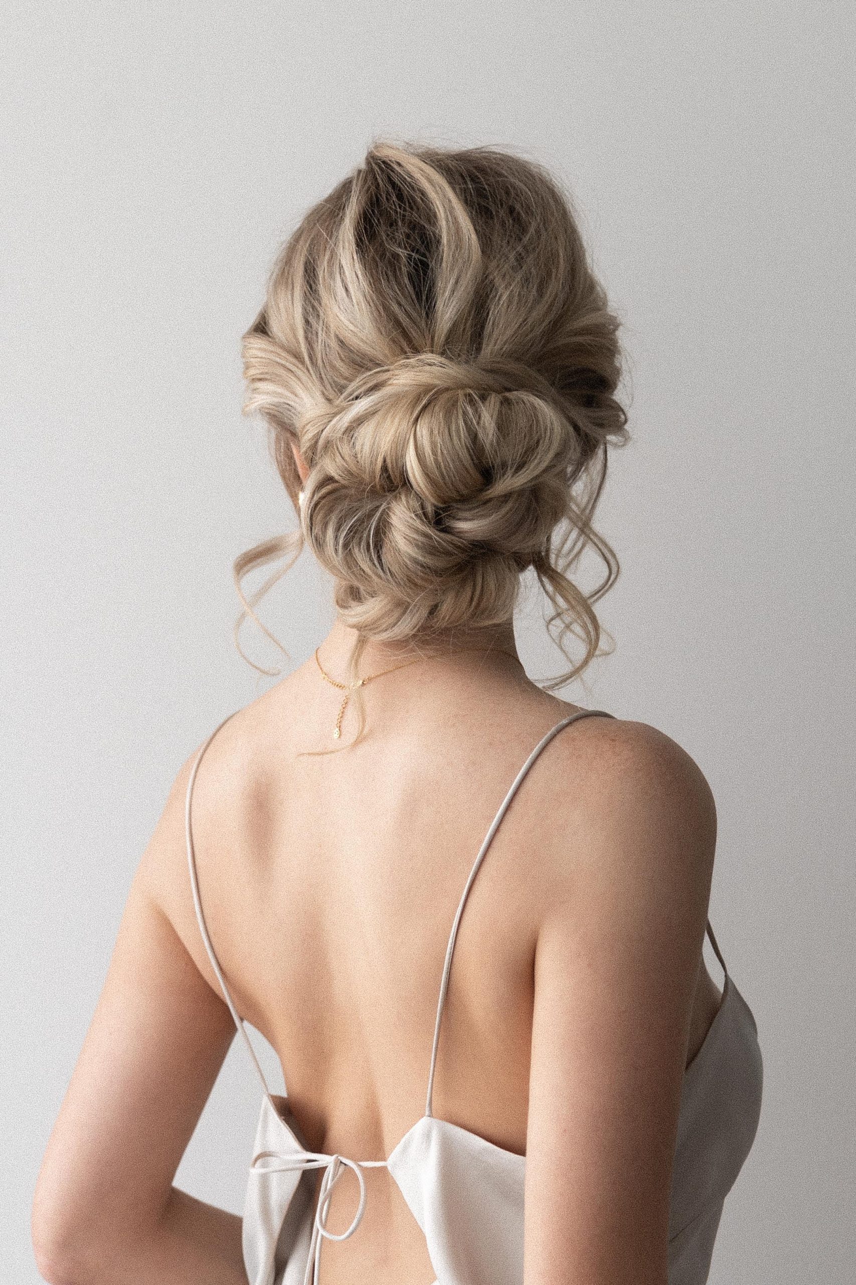 Messy Blonde Wavy Low Bun