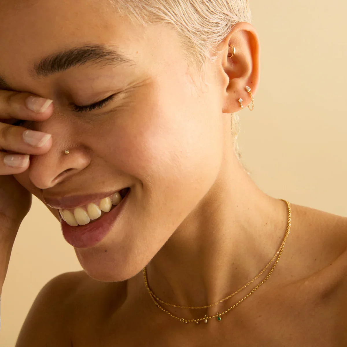 Sparkling Nose Stud with Layered Gold Necklaces Sparkling Nose Stud with Layered Gold Necklaces — Nose Piercing Ideas
