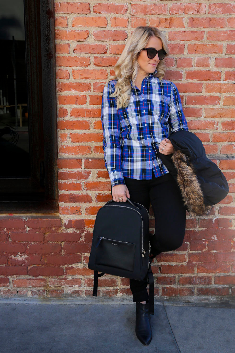 Casual Layers: Plaid Shirt, Fur-Trimmed Jacket, and Ankle Boots with a Black Backpack — Backpack Outfits Women