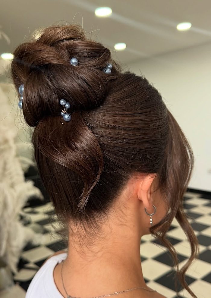 37 Elegant Wedding Hairstyles: Pearl-Embellished High Bridal Bun for Brunette Hair