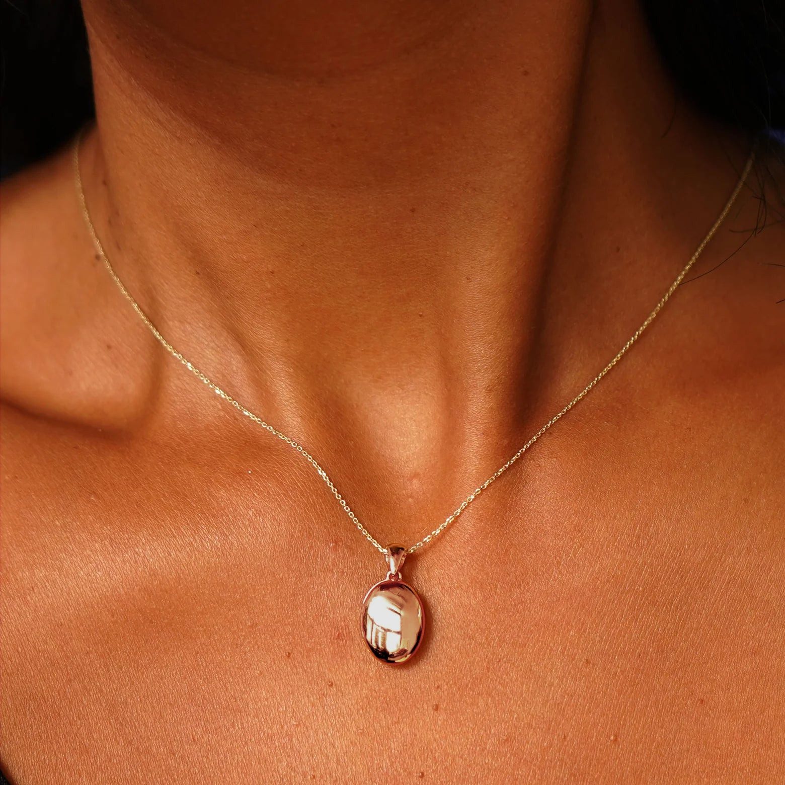 Simple Gold Oval Locket on Brown Skin — Locket Necklaces