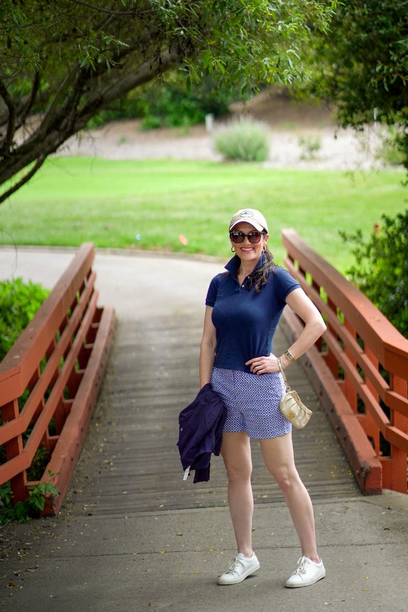 Navy Polo and Patterned Skort with White Cap — Golf Tournament Outfits