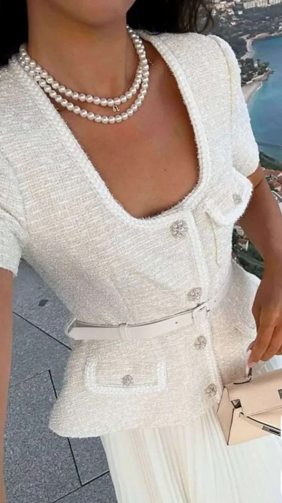 Layered Pearl Necklaces with White Tweed Jacket and Pleated Skirt Layered Pearl Necklaces with White Tweed Jacket and Pleated Skirt — Pearl Necklace Outfits