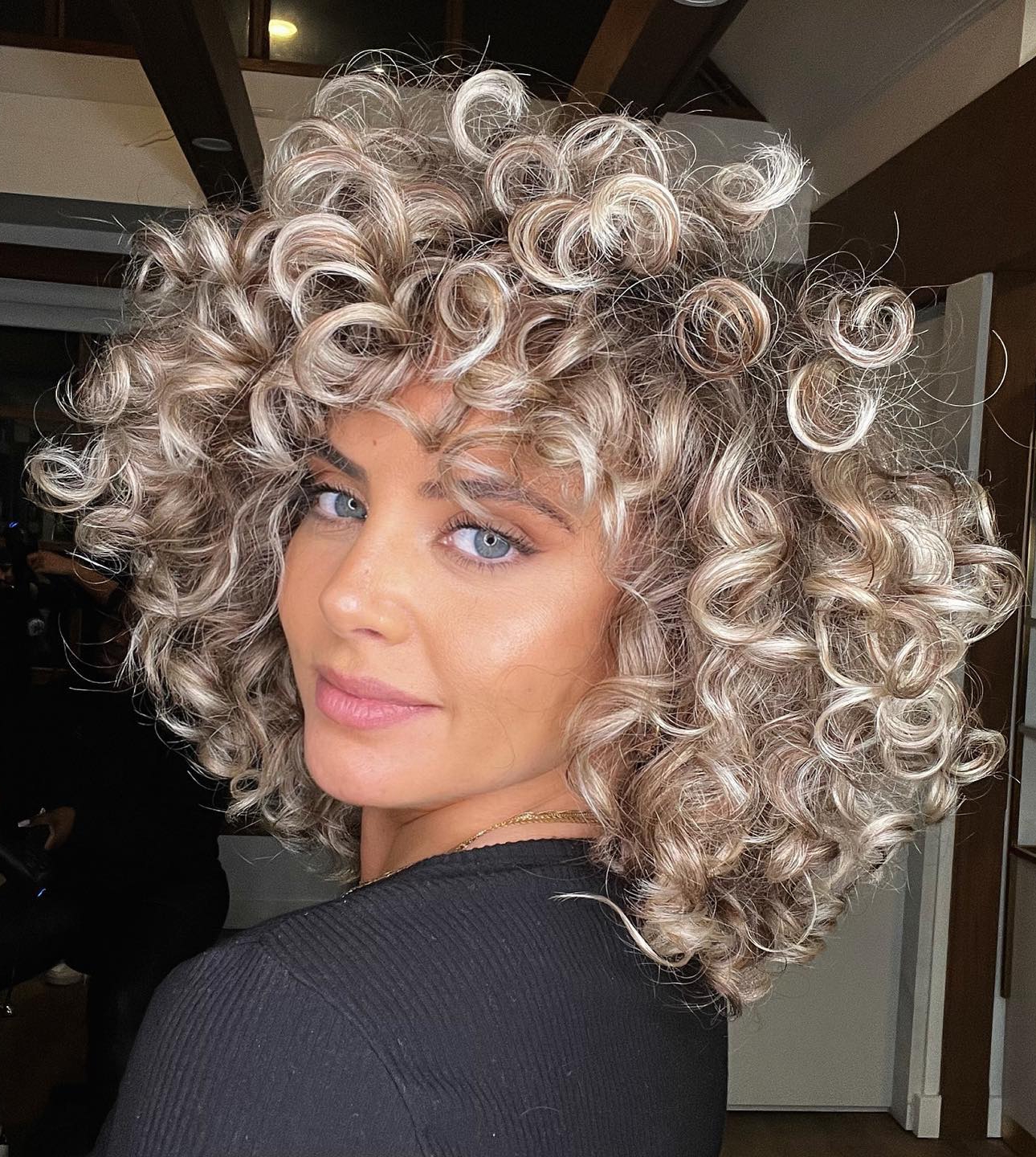 Black Knit Long-Sleeved Top with Blonde Curly Bangs Black Knit Long-Sleeved Top with Blonde Curly Bangs
