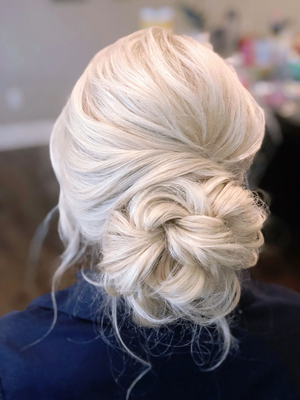 Platinum Blonde Braided Updo With Loose Tendrils Platinum Blonde Braided Updo With Loose Tendrils — Mother of the Bride Hairstyles