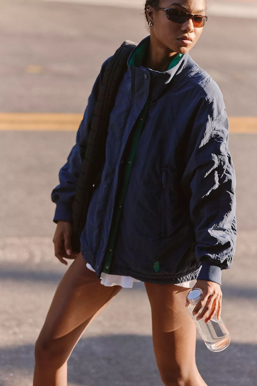 Navy Windbreaker Layered Over Green Shirt and White Shorts Navy Windbreaker Layered Over Green Shirt and White Shorts — Windbreaker Outfits