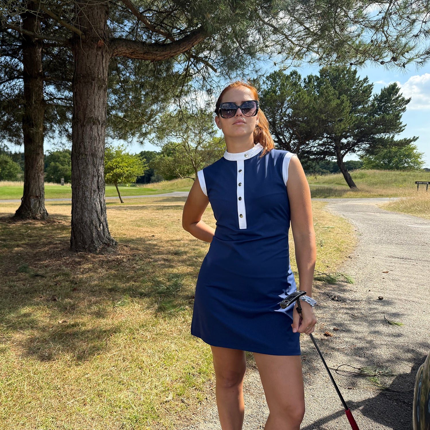 Dark Blue Sleeveless Golf Dress with White Button Neck Dark Blue Sleeveless Golf Dress with White Button Neck — Golf Dresses
