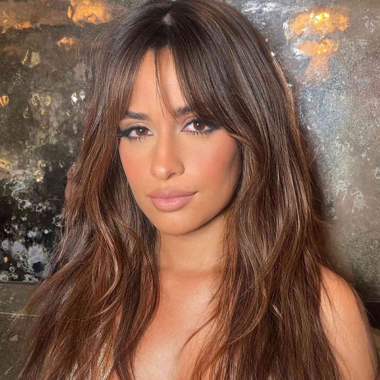 Low-Cut Top and Brown Streaked Wispy Bangs with Smoky Eyes
