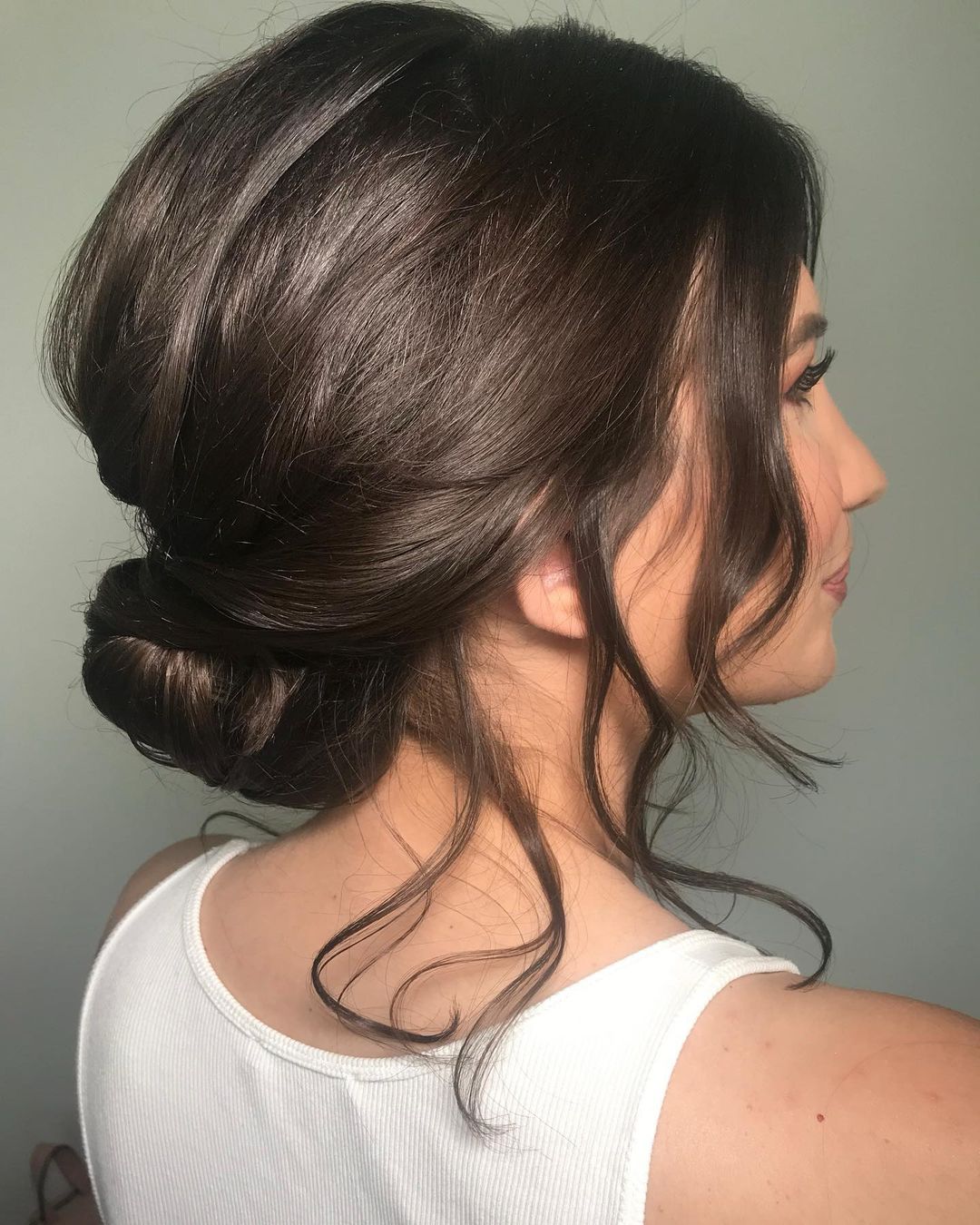 Loose Dark Brown Chignon With Wispy Bangs Loose Dark Brown Chignon With Wispy Bangs