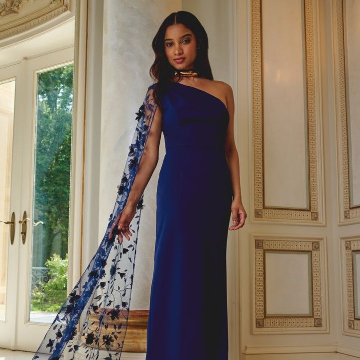 Royal Blue One-Shoulder Gown with Floral Appliqué Sheer Cape Royal Blue One-Shoulder Gown with Floral Appliqué Sheer Cape — Pageant Dresses