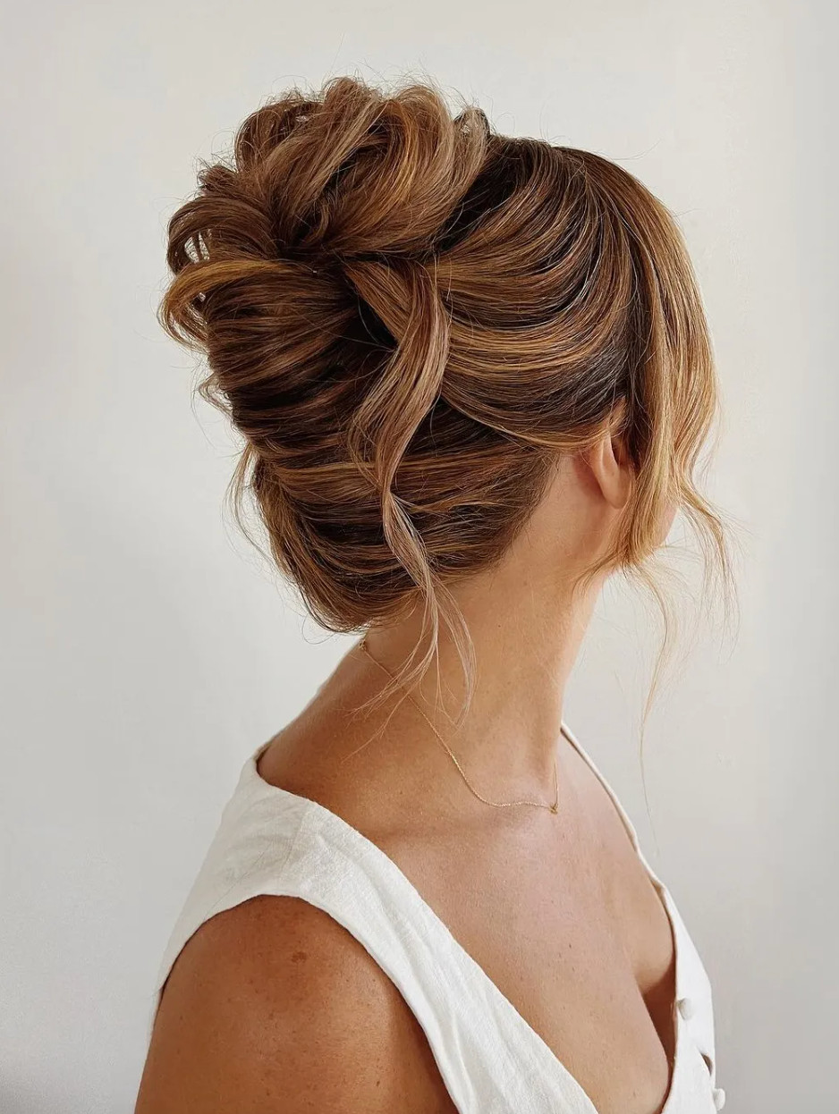 Textured Brown Bun with Face-Framing Textured Brown Bun with Face-Framing — Low Bun with Curtain Bangs