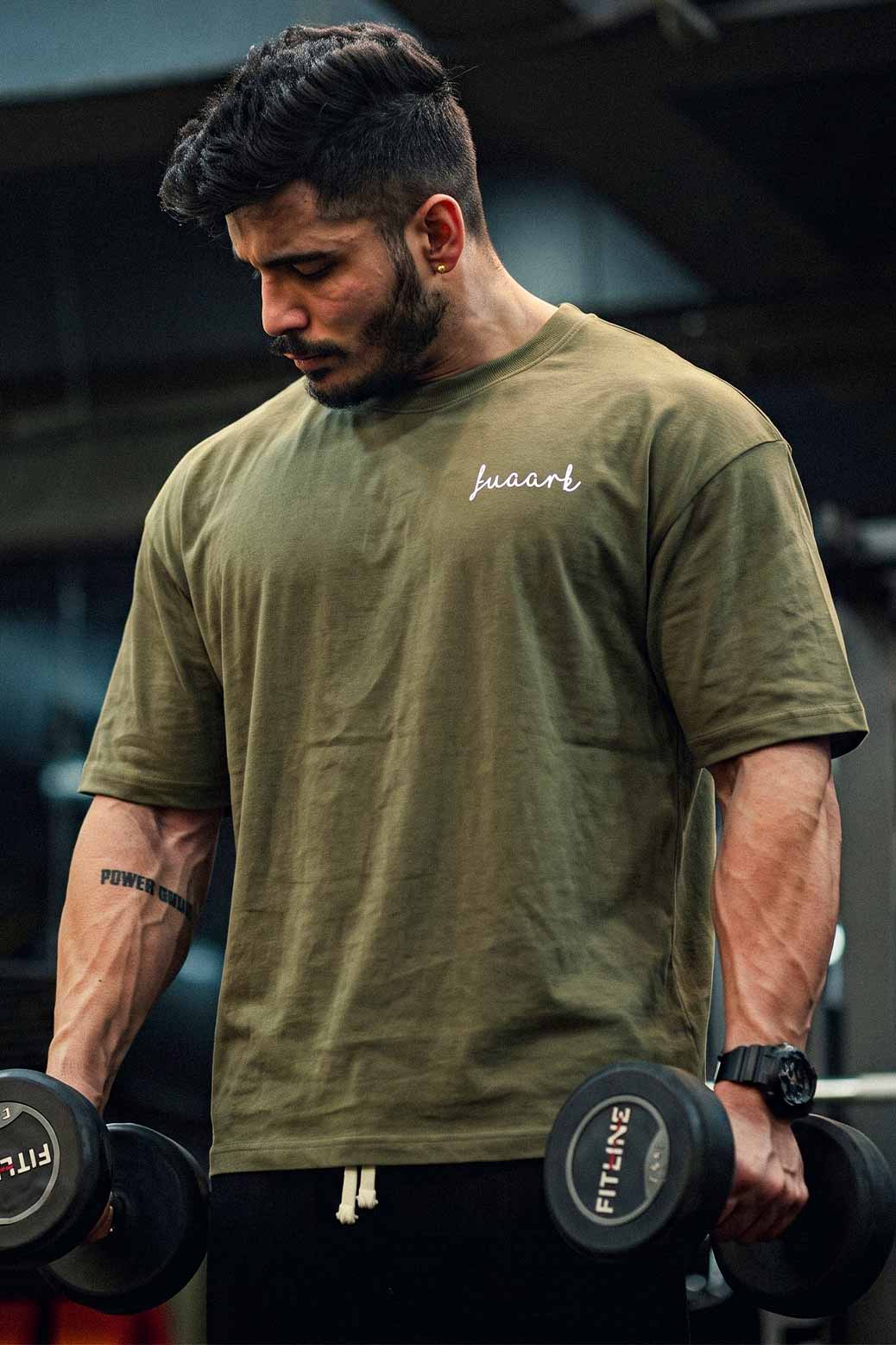 Relaxed Gym Style with an Olive Green Graphic Tee and Black Pants — Mens Gym Outfits