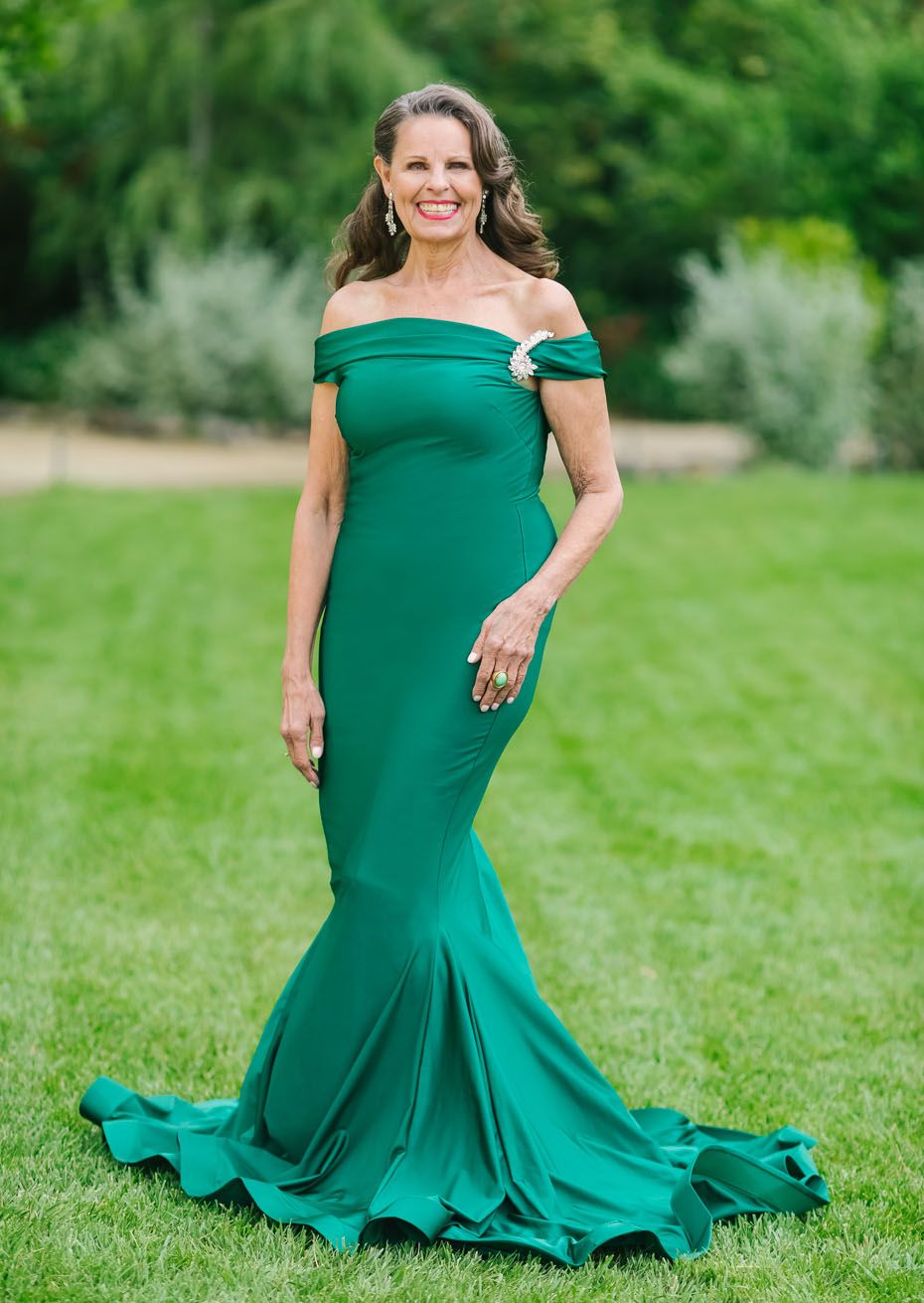 Emerald Green Off-the-Shoulder Fishtail Gown with Brooch Detail Emerald Green Off-the-Shoulder Fishtail Gown with Brooch Detail — Mother of the Bride Dresses