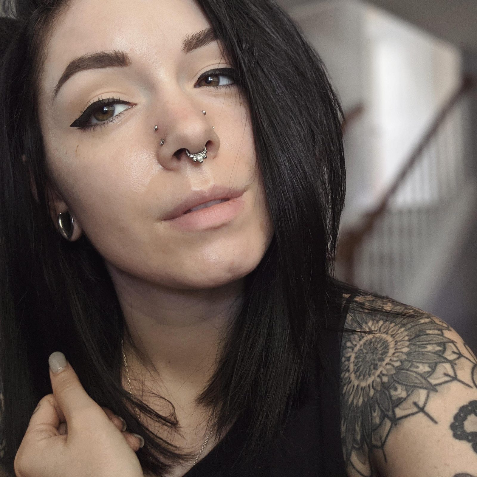 Multiple Silver Studs and Septum Ring with a Black Tank Top Multiple Silver Studs and Septum Ring with a Black Tank Top — Nose Piercing Ideas