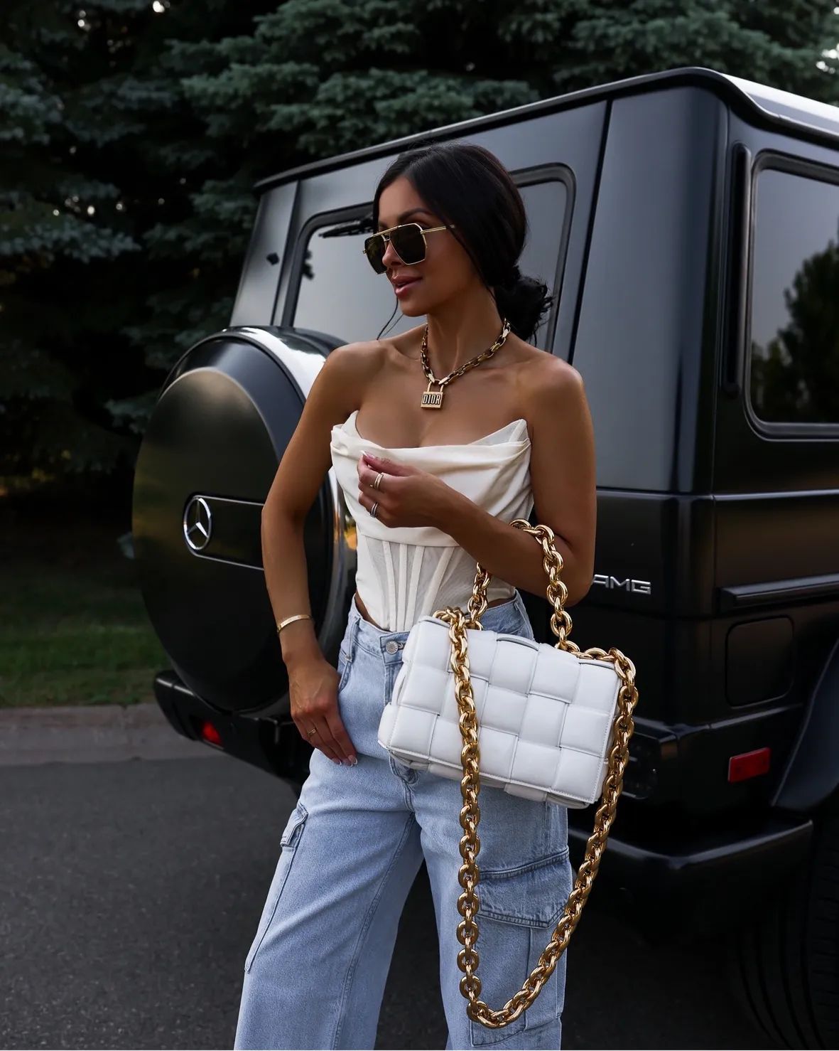 Corset Top and Cargo Jeans with a White Bottega Veneta Bag by an SUV Corset Top and Cargo Jeans with a White Bottega Veneta Bag by an SUV — Bottega Veneta Bag Outfits