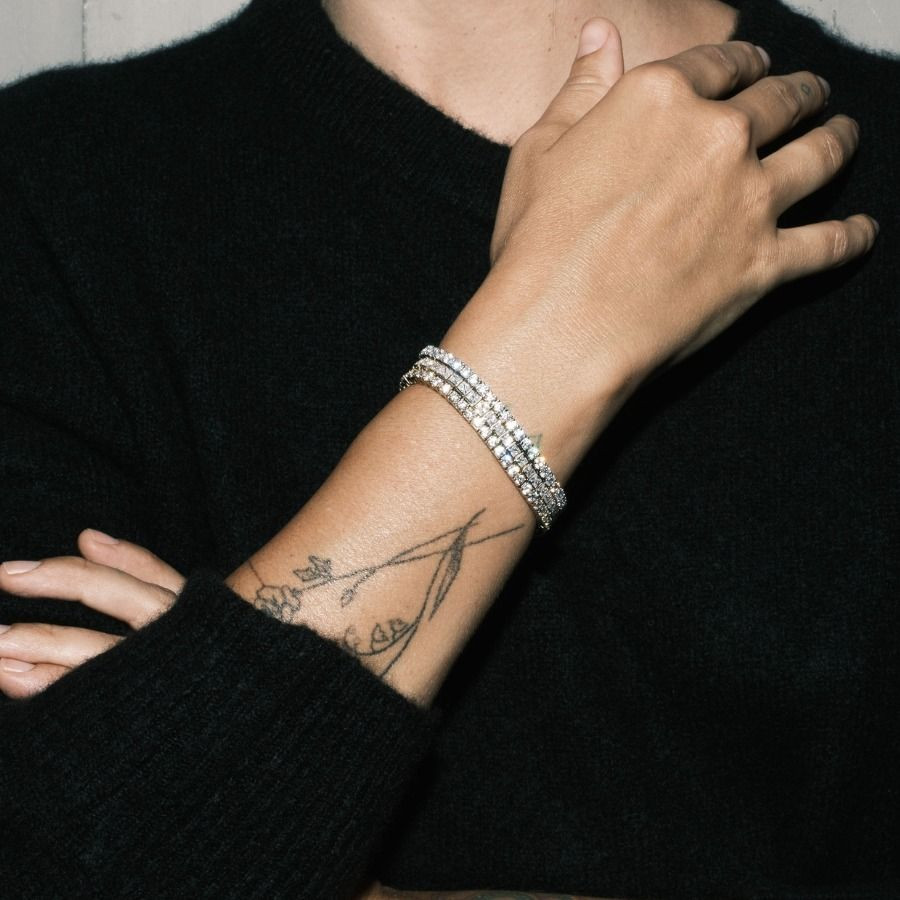 Effortless Sparkle: Stacked Diamond Bracelets with Black Sweater Effortless Sparkle: Stacked Diamond Bracelets with Black Sweater — Tennis Bracelets