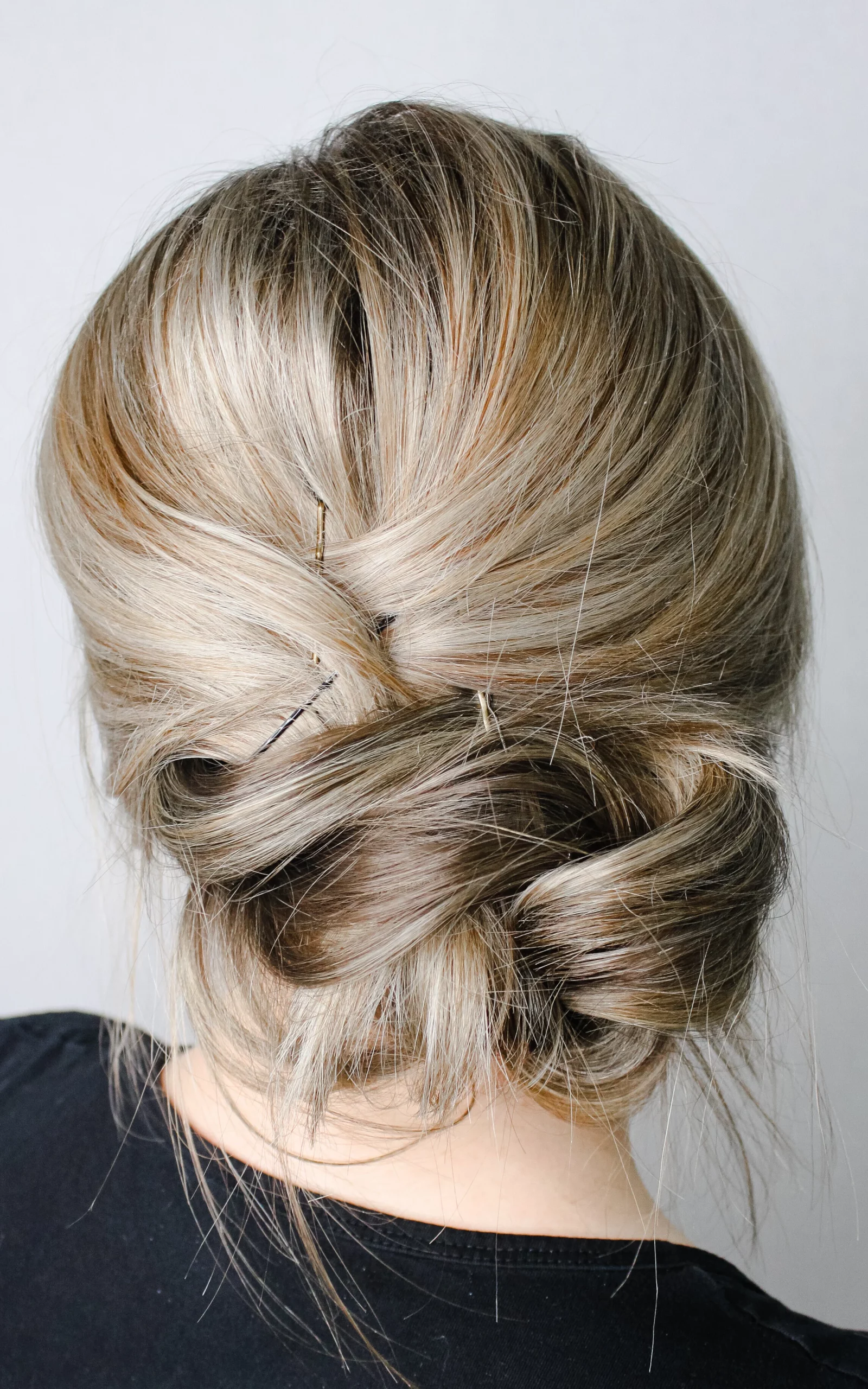 Low Bun With Braided Accent And Floral Accessory — Date Night Hairstyles