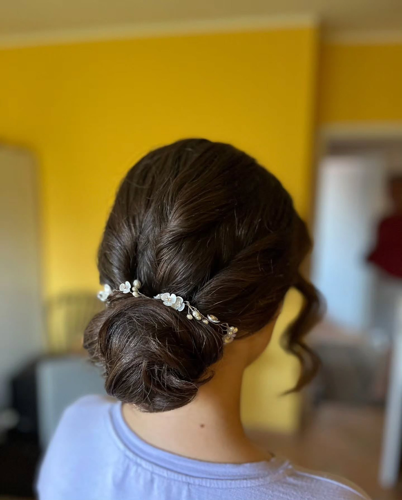 Dark Brown Twisted Bun with Decor — Low Bun with Bangs
