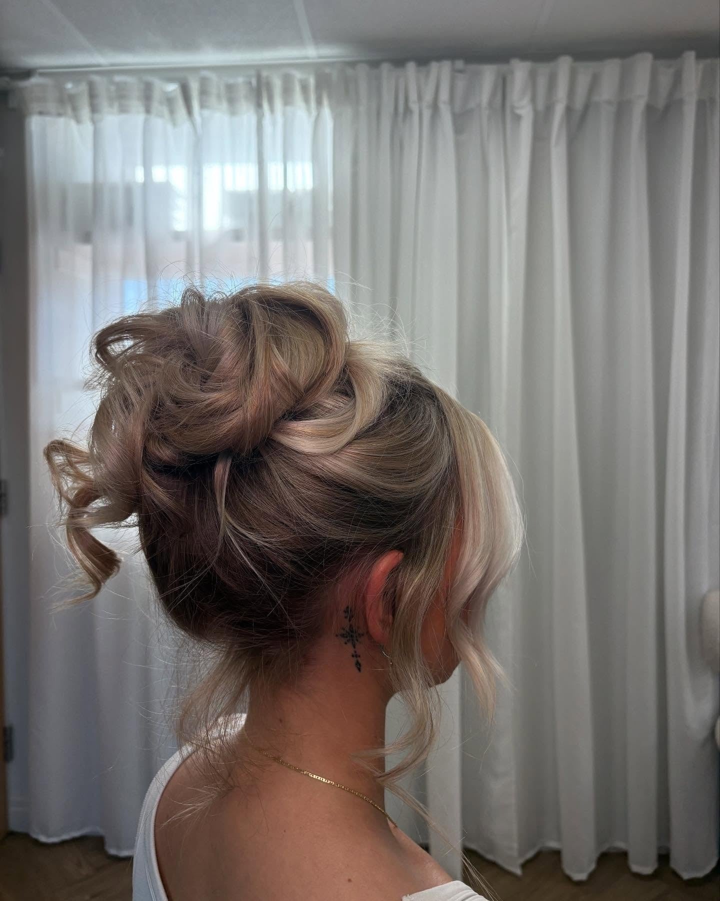Mid-Back Voluminous Messy Bun with Curls