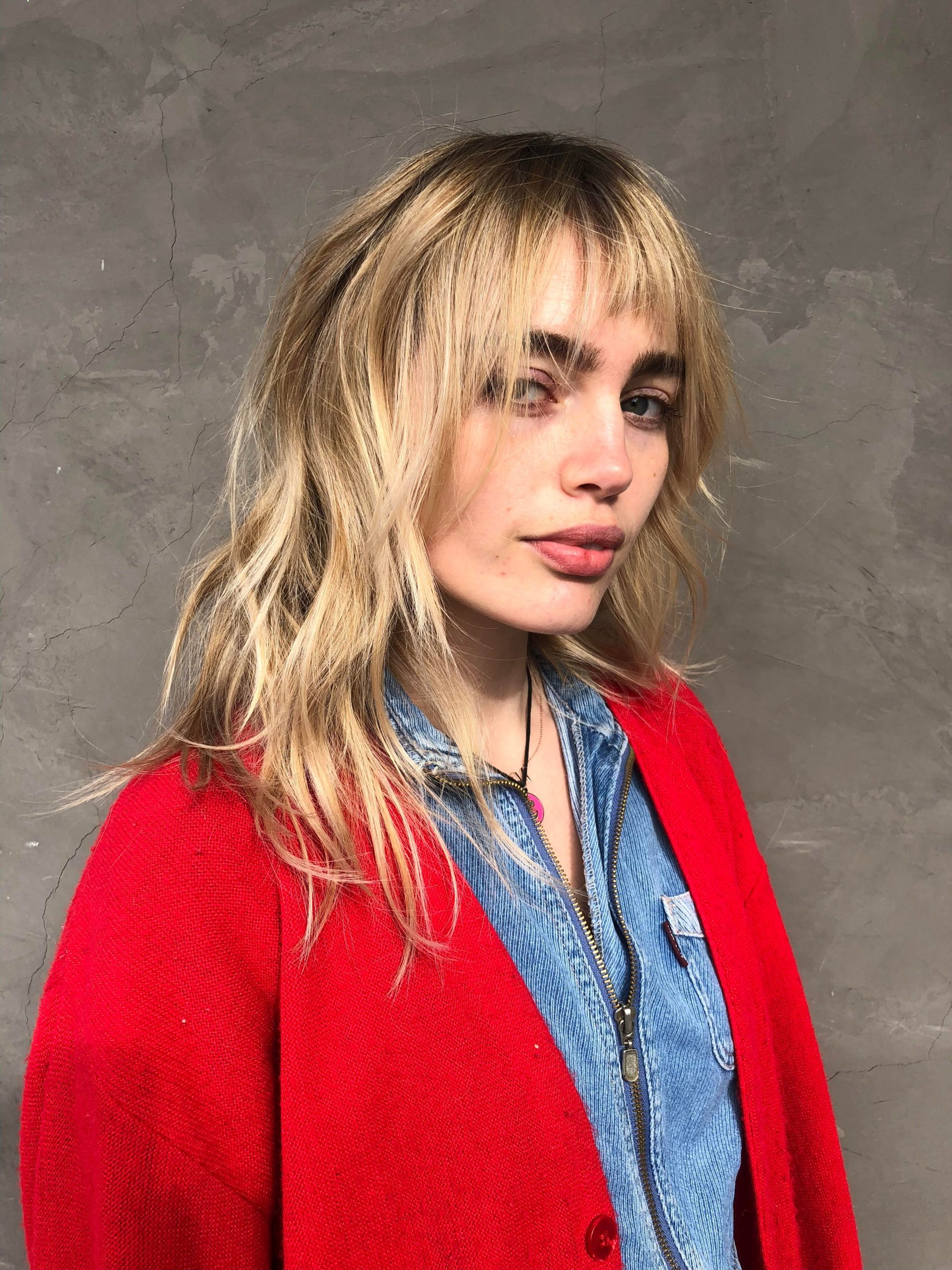 Denim Jumpsuit Under Red Cardigan with Baby Bangs Denim Jumpsuit Under Red Cardigan with Baby Bangs