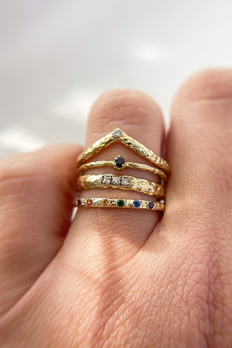 Diverse Textures and Stones in a Gold Ring Stack Diverse Textures and Stones in a Gold Ring Stack