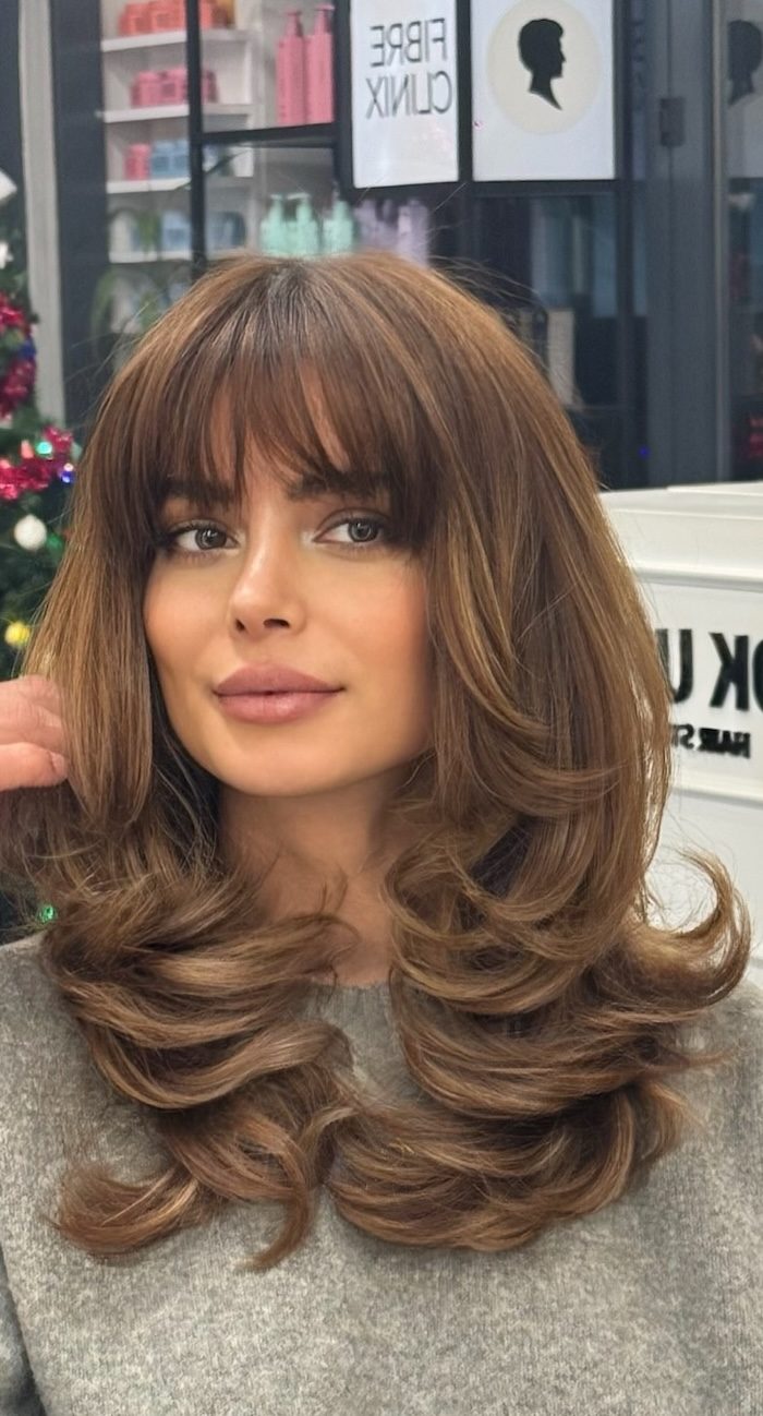 50 Long Fringe Hairstyles: 90s Blowout Fringe with Chestnut Brown Butterfly Layers