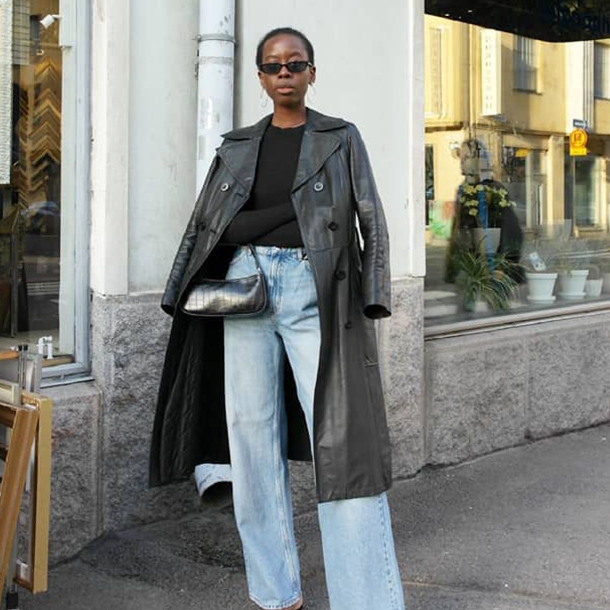 Light Blue Wide Leg Jeans with a Leather Trench Coat and Heeled Sandals
