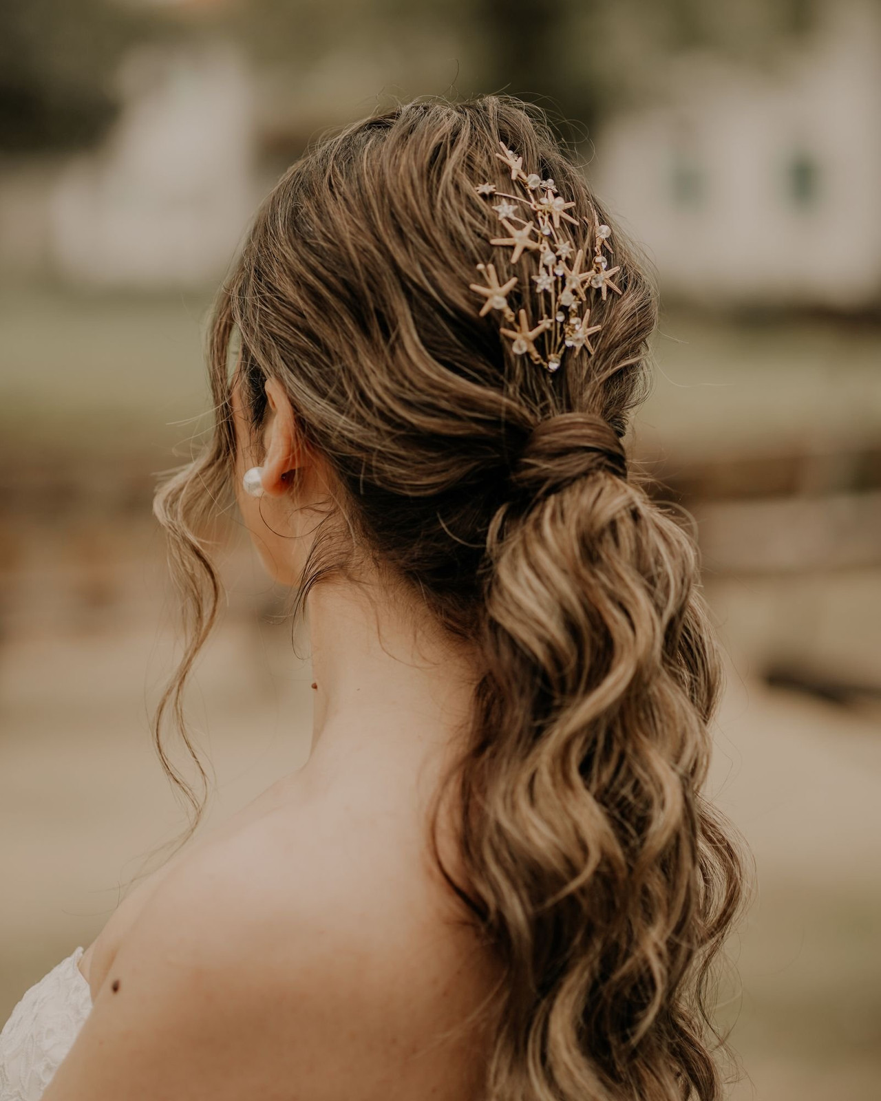 Low Ponytail With Starfish Accessory Low Ponytail With Starfish Accessory — Rehearsal Dinner Hairstyles