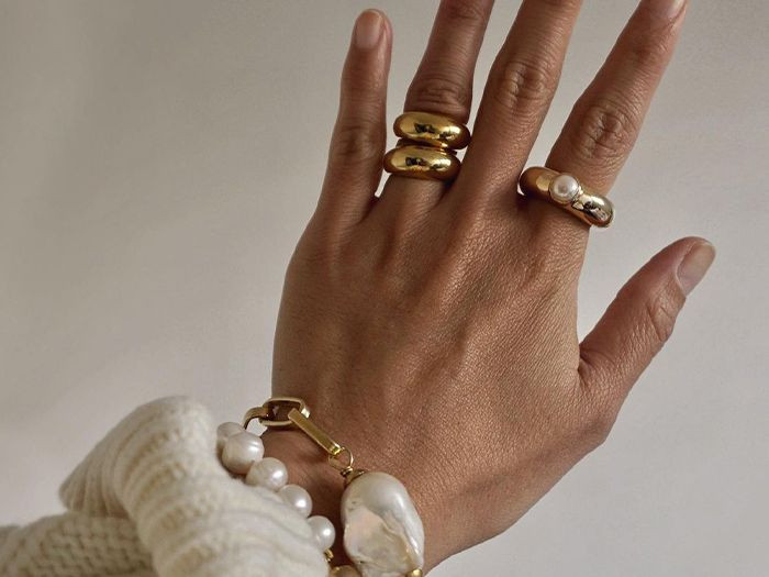 Stacked Gold Rings with a Cream Knit Sweater and Pearl Bracelet — Chunky Rings