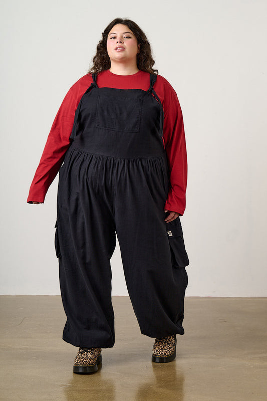 Voluminous Black Overalls with Red Shirt and Platform Shoes Voluminous Black Overalls with Red Shirt and Platform Shoes