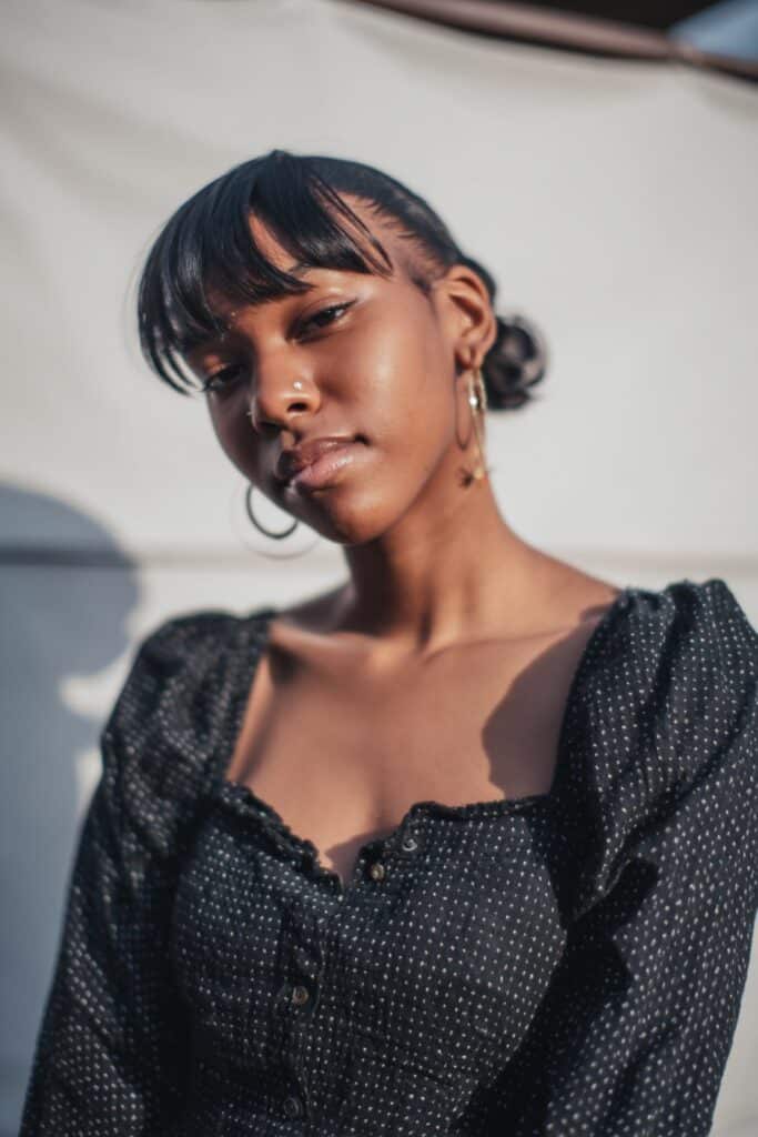 Dark Brown Low Bun and Blunt Bangs — Slick Back Hairstyles