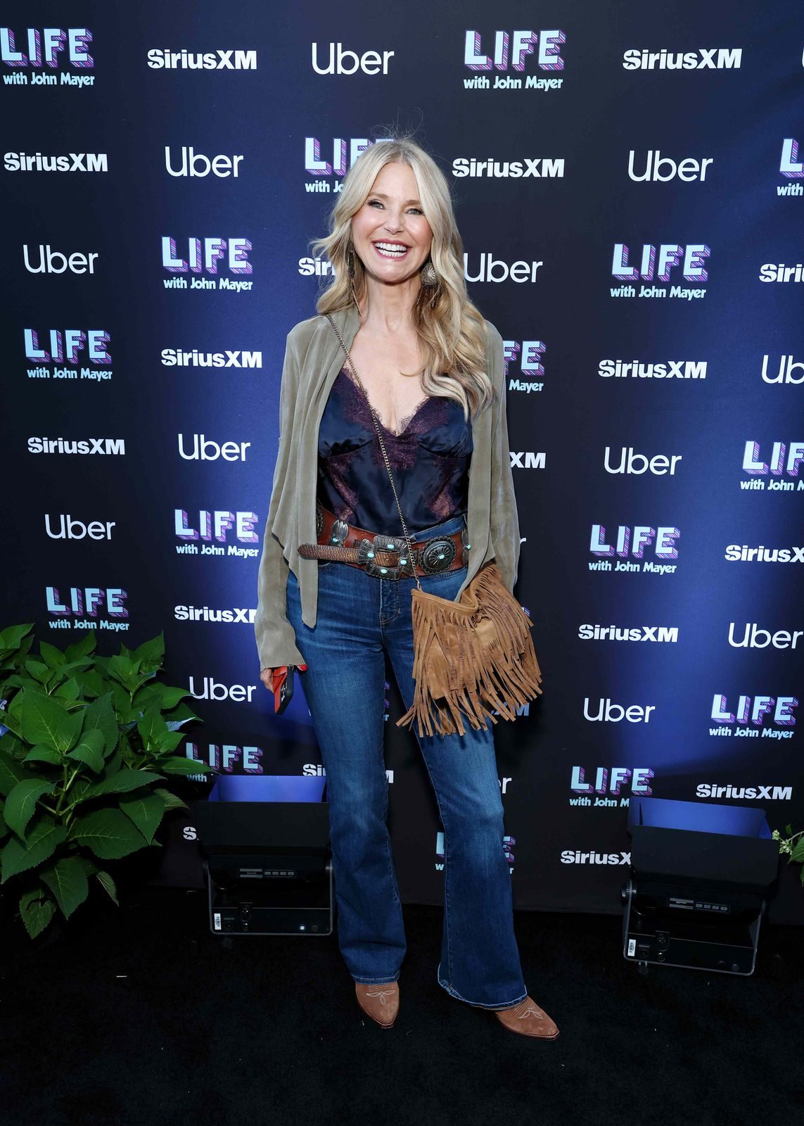 Southwestern Charm: Blue Jeans with Concho Belt and Fringed Bag Southwestern Charm: Blue Jeans with Concho Belt and Fringed Bag — Bootcut Jeans Outfits