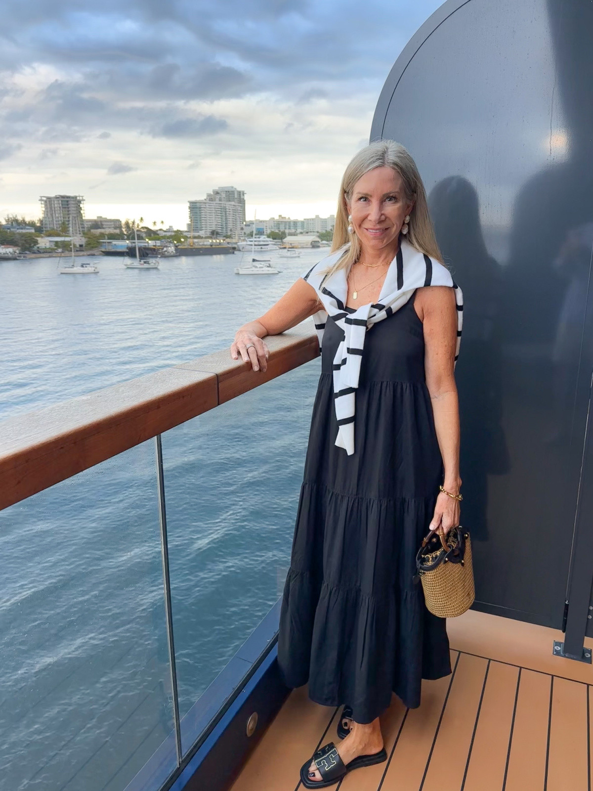 Black Tiered Maxi Dress with a Striped Sweater Accent — Cruise Dinner Outfits