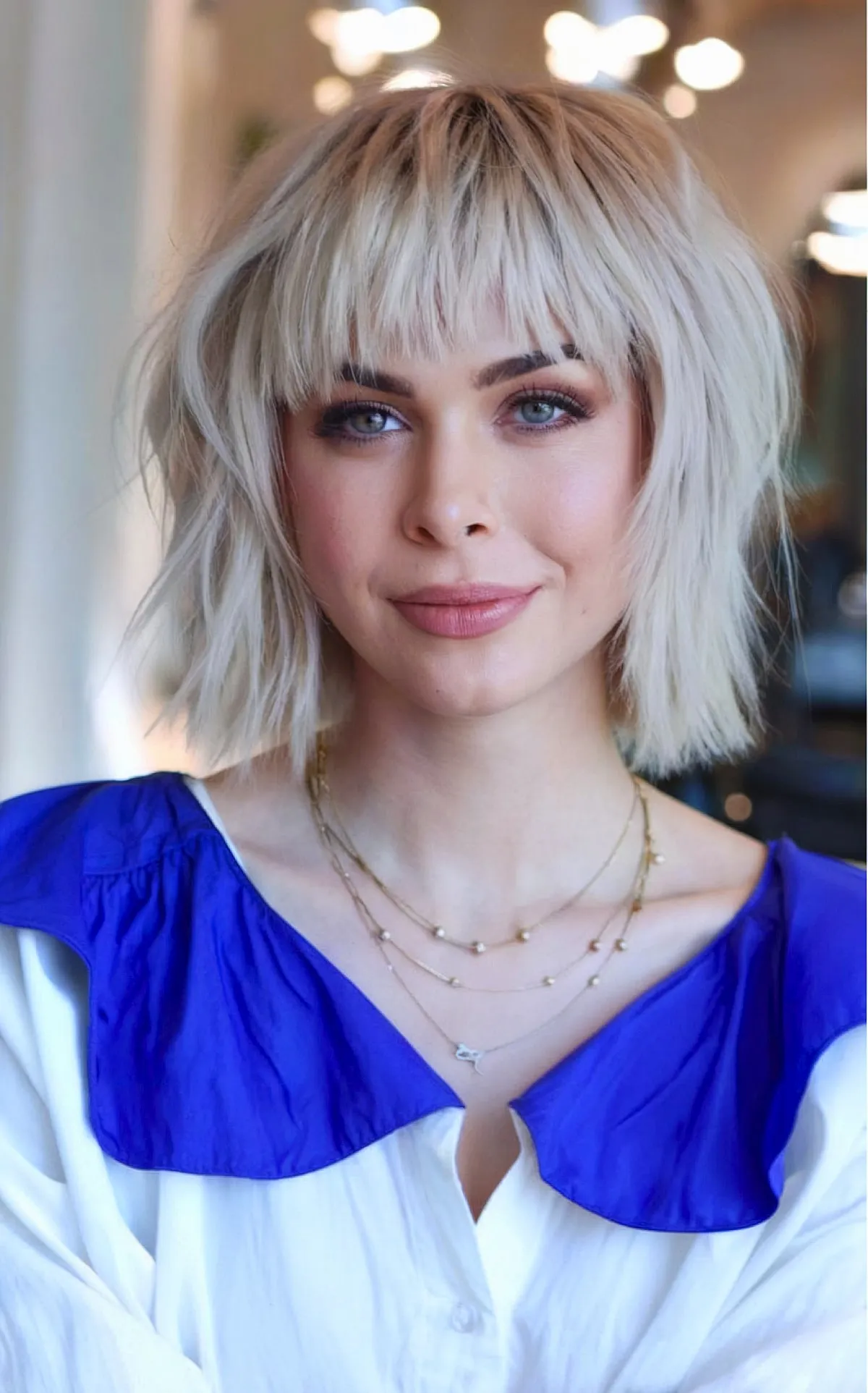 Layered Necklaces and Blue Collar: Polished Casual with Blunt Bangs
