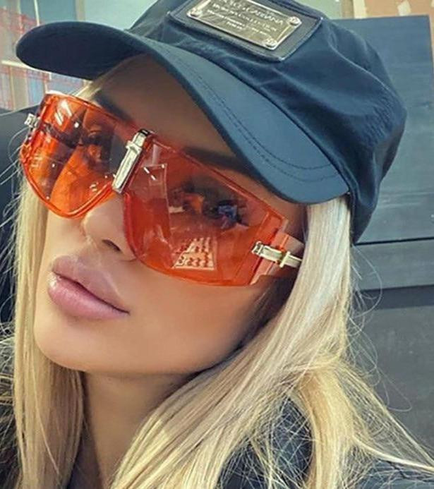 Angular Orange Sunglasses with a Black Baseball Cap — Oversized Sunglasses Outfits