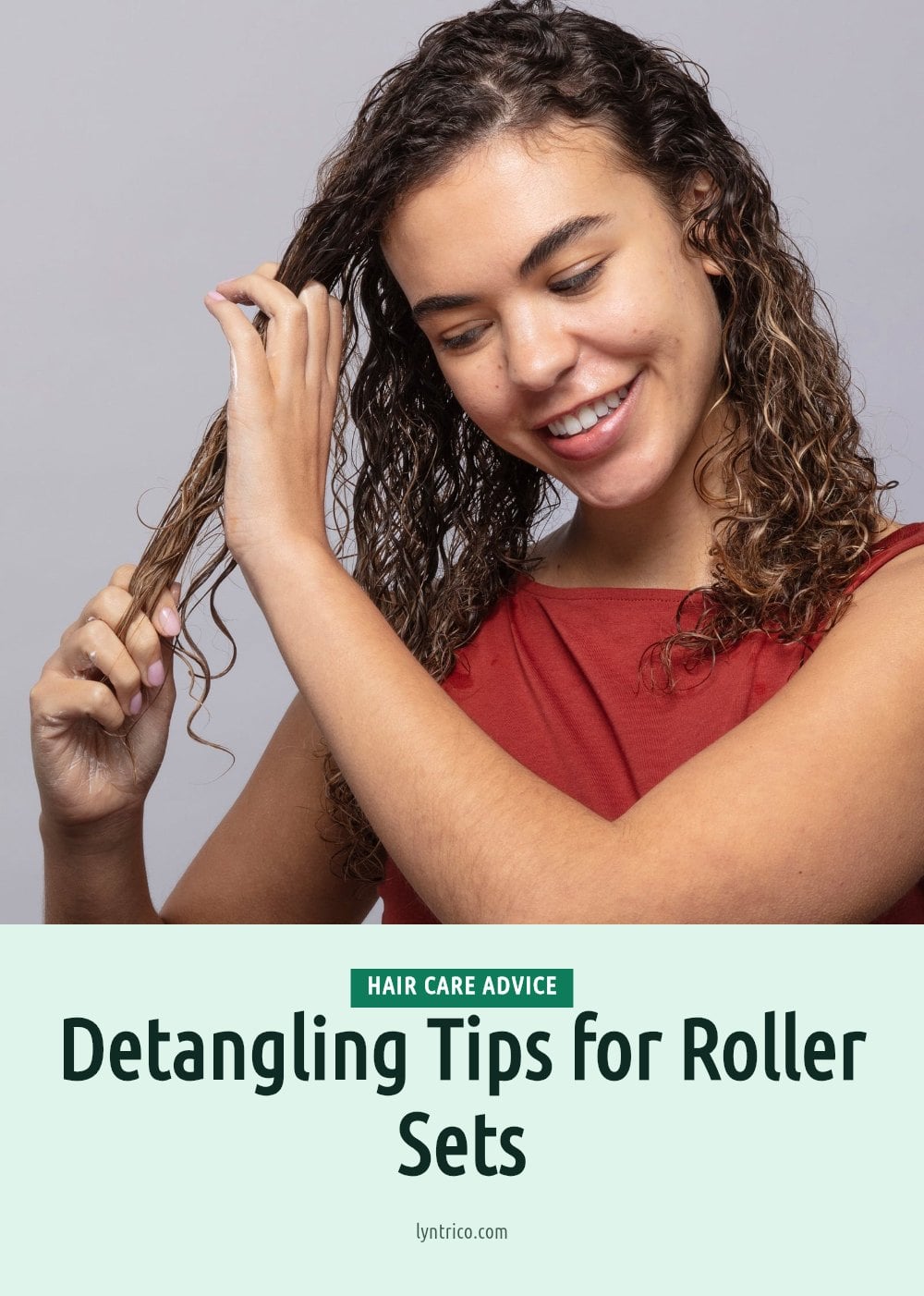 A woman with wet curly hair smiles as she gently detangles a section with her fingers A woman with wet curly hair smiles as she gently detangles a section with her fingers — how to use hair rollers