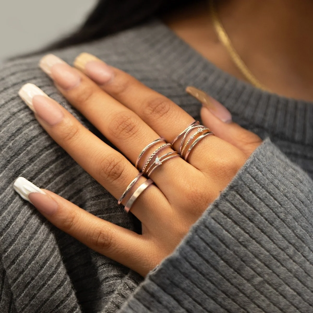 Delicate Silver Rings on a Grey Knit Delicate Silver Rings on a Grey Knit — Stacked Rings
